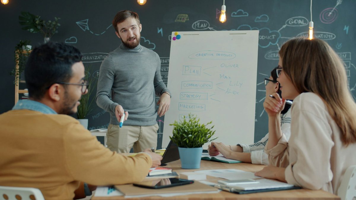 Team collaborating around a whiteboard